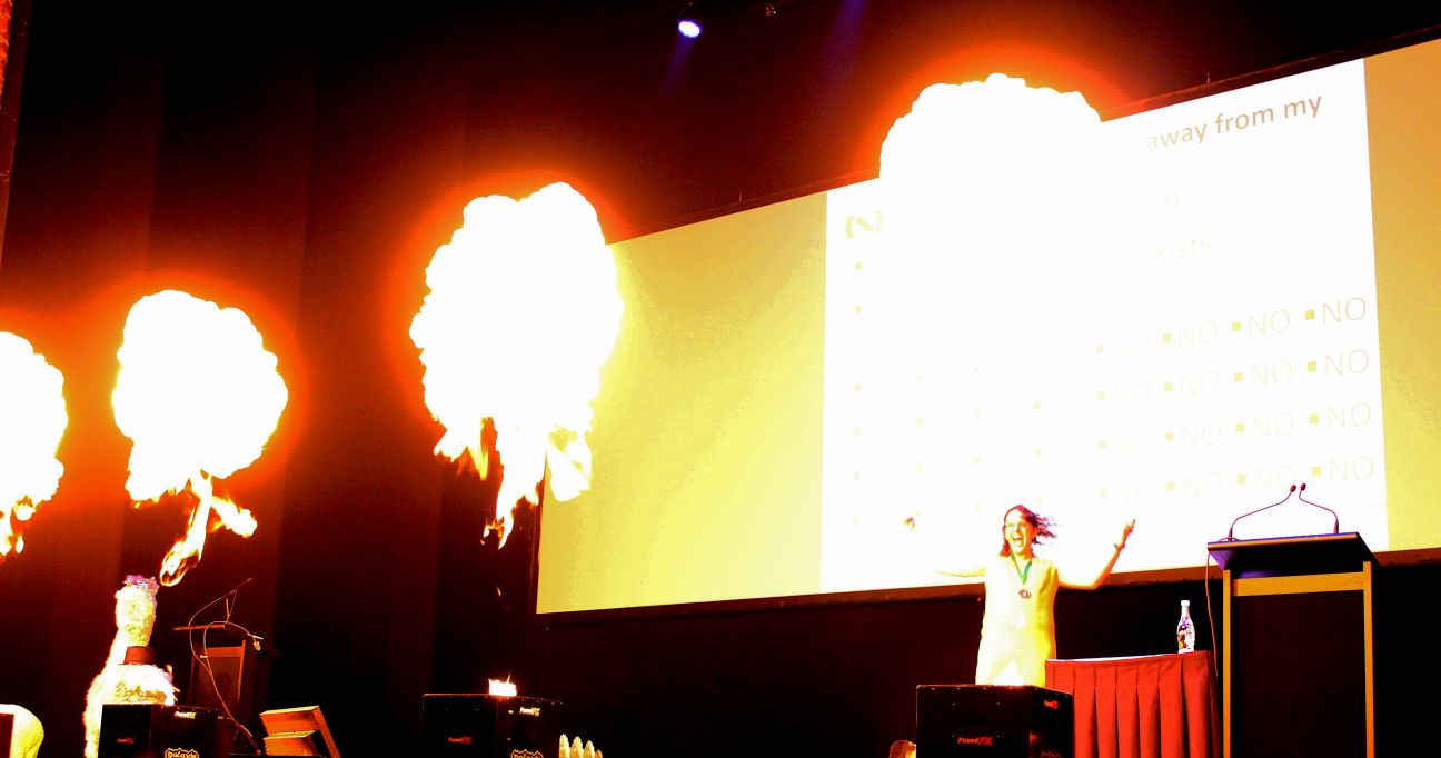 Kate Pearce Speaking at Kiwicon 9, Surrounded by flames as the slide is filled with NO NO NO